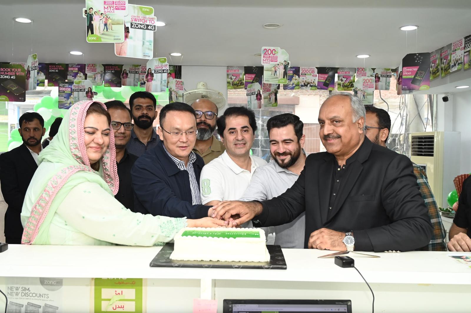 Cake-cutting ceremony celebrating a ZONG store opening with the Barkat Traders team